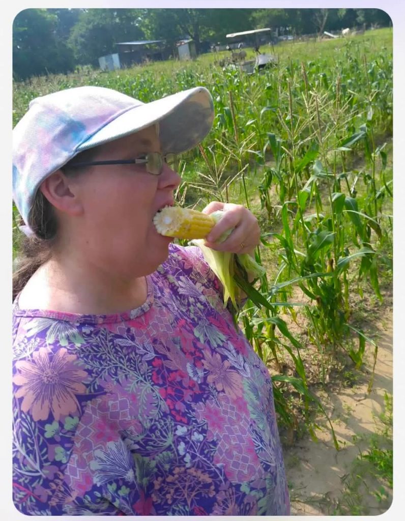 Kellrae taste testing corn in the field